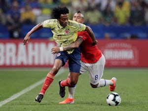 Colombia's Juan Cuadrado in action with Chile's Arturo Vidal in the Copa America quarter-finals on June 28, 2019
