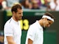 Britain's Andy Murray and France's Pierre-Hugues Herbert look dejected after losing their second round double's match against Croatia's Franko Skugor and Nikola Mektic on July 6, 2019