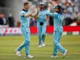 England's Chris Woakes celebrates taking the wicket of New Zealand's Tom Latham with Eoin Morgan on July 14, 2019
