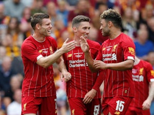 Liverpool's James Milner celebrates scoring their first goal with Harry Wilson and Alex Oxlade-Chamberlain on July 14, 2019