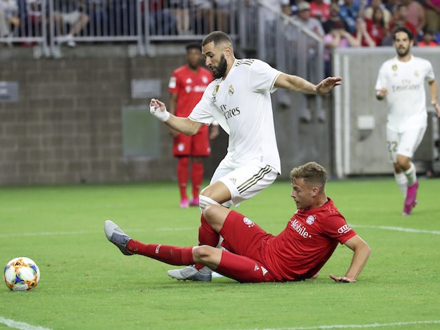 Real Madrid's Karim Benzema in action with Bayern Munich's Joshua Kimmich in the International Champions Cup on July 20, 2019