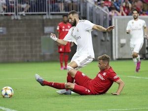 Real Madrid's Karim Benzema in action with Bayern Munich's Joshua Kimmich in the International Champions Cup on July 20, 2019