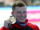 Adam Peaty poses with his gold medal on July 24, 2019