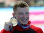 Adam Peaty poses with his gold medal on July 24, 2019