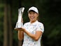 Japan's Hinako Shibuno celebrates with trophy after making a birdie putt on the 18th hole to win the Women's British Open on August 4, 2019