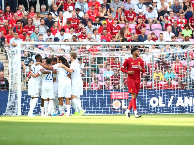 Memphis Depay celebrates with his Lyon teammates after converting an early penalty against Liverpool on July 31, 2019