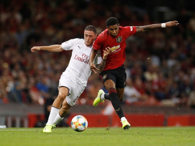 Manchester United's Marcus Rashford in action with AC Milan's Davide Calabria on August 3, 2019