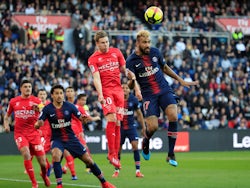 Paris Saint Germain's Maxim Choupo-Moting in action with Nimes's Renaud Ripart in Ligue 1 on February 23, 2019