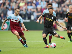 Jack Wilshere and David Silva compete for the ball as West Ham United face Manchester City on August 10, 2019.
