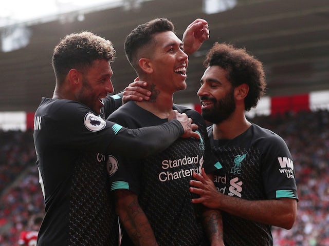 Liverpool's Roberto Firmino celebrates scoring their second goal with teammates Alex Oxlade-Chamberlain and Mohamed Salah on August 17, 2019