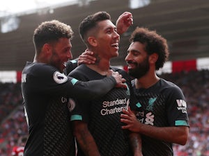 Liverpool's Roberto Firmino celebrates scoring their second goal with teammates Alex Oxlade-Chamberlain and Mohamed Salah on August 17, 2019
