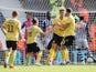 Millwall's Tom Bradshaw celebrates with teammates after he scores their first goal on August 13, 2019