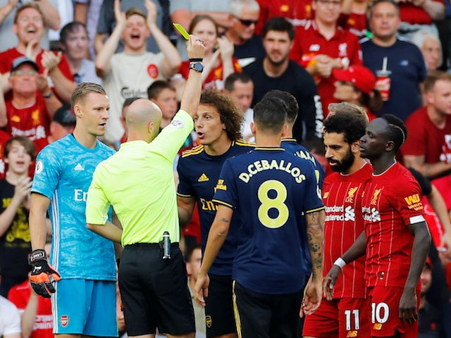 Liverpool are awarded a penalty and Arsenal's David Luiz is shown a yellow card by referee Anthony Taylor after a foul on Liverpool's Mohamed Salah on August 24, 2019