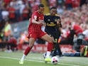 Joel Matip and Joe Willock in action during the Premier League game between Liverpool and Arsenal on August 24, 2019