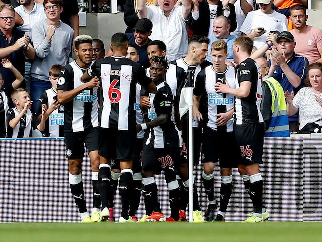 Fabian Schar celebrates scoring with Newcastle teammates on August 31, 2019