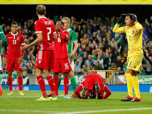 Luxembourg's Kevin Malget is down and dejected after scoring an own goal and Northern Ireland's first as Luxembourg's Anthony Moris reacts on September 5, 2019