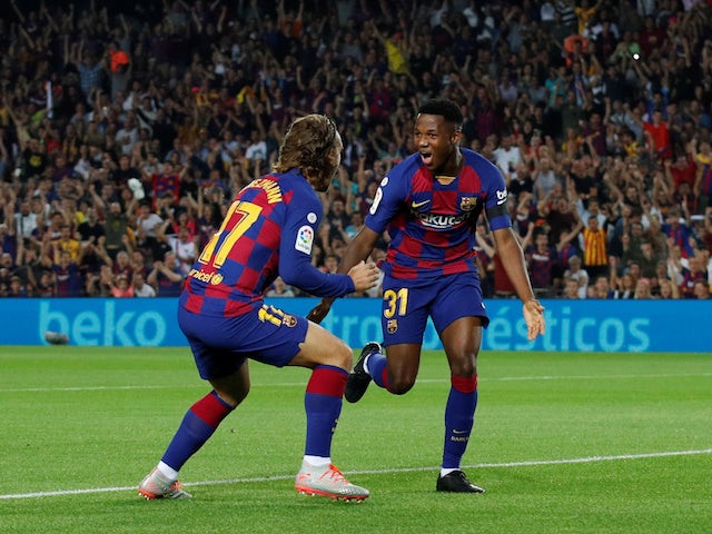 Barcelona's Anssumane Fati celebrates scoring their first goal with Antoine Griezmann on September 14, 2019