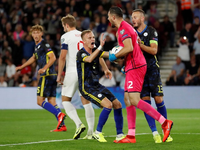 Kosovo's Aro Muric celebrates with Amir Rrahmani after saving a penalty from England's Harry Kane on September 10, 2019