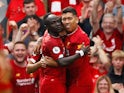 Sadio Mane celebrates his side's second with Roberto Firmino during the Premier League game between Liverpool and Newcastle United on September 14, 2019
