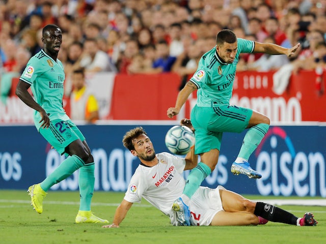 Real Madrid's Eden Hazard in action with Sevilla's Franco Vazquez in La Liga on September 22, 2019