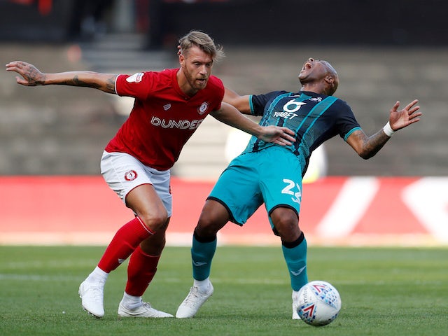 Andre Ayew and Nathan Baker in action on September 21, 2019