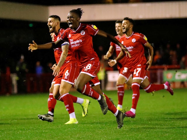 Crawley Town's David Sesay and teammates celebrate winning the penalty shootout against Stoke on September 24, 2019