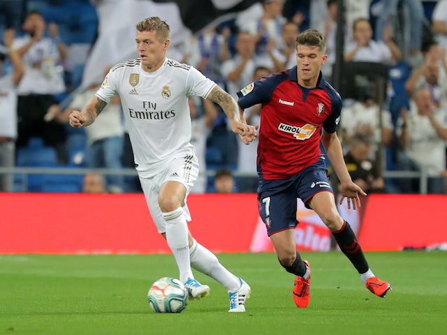 Real Madrid's Toni Kroos in action with Osasuna's Marc Cardona in La Liga on September 25, 2019