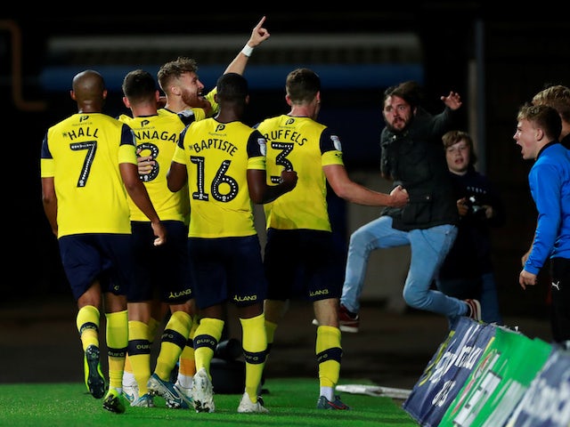 Oxford United's Matty Taylor celebrates scoring their second goal against West Ham with teammates and fans on September 25, 2019
