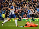 Brighton and Hove Albion's Aaron Connolly celebrates scoring their third goal as Tottenham Hotspur's Paulo Gazzaniga looks dejected on October 5, 2019