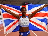 Great Britain's Dina Asher-Smith celebrates after winning gold on October 2, 2019