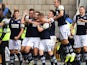 Tom Bradshaw celebrates with Millwall teammates after scoring on October 5, 2019