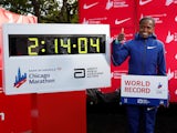 Kenya's Brigid Kosgei celebrates winning the women's marathon next to her new world record time