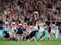 Japan's Isileli Nakajima and team mates celebrate at the end of the match as Scotland players look dejected on October 13, 2019