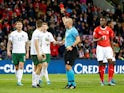 Republic of Ireland's Seamus Coleman is shown a red card by referee Szymon Marciniak on October 15, 2019