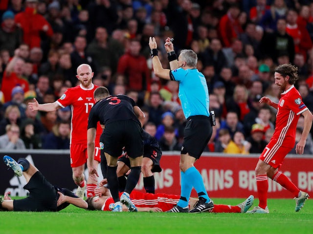 Wales' Daniel James down injured as referee Bjorn Kuipers gestures on October 13, 2019