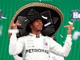 Lewis Hamilton celebrates winning the race on the podium whilst wearing a sombrero on October 27, 2019