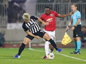 Manchester United's Aaron Wan-Bissaka in action with Partizan Belgrade's Takuma Asamo in the Europa League on October 24, 2019