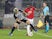 Manchester United's Aaron Wan-Bissaka in action with Partizan Belgrade's Takuma Asamo in the Europa League on October 24, 2019