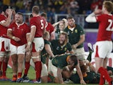 South Africa celebrate after the match as Wales look dejected on October 27, 2019
