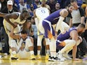Golden State Warriors forward Draymond Green (23) helps up guard Stephen Curry (30) after an injury during the third quarter against the Phoenix Suns at Chase Center on October 31, 2019.