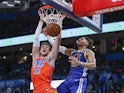 Oklahoma City Thunder forward Mike Muscala (33) dunks in front of Golden State Warriors guard Jordan Poole (3) during the second half at Chesapeake Energy Arena