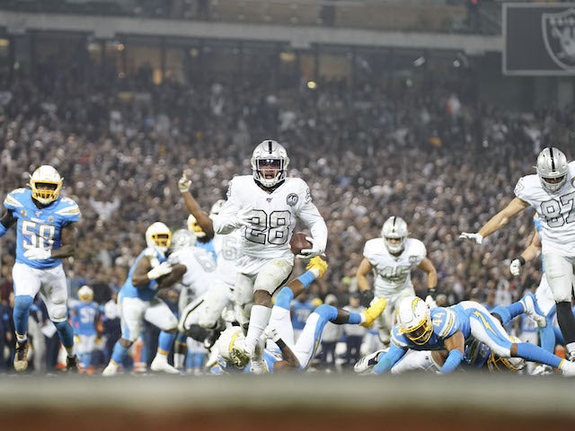 Oakland Raiders running back Josh Jacobs (28) scores the game-winning touchdown against the Los Angeles Chargers during the fourth quarter at Oakland Coliseum on November 8, 2019