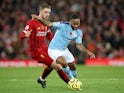 Liverpool midfielder Jordan Henderson in action with Manchester City's Raheem Sterling in the Premier League on November 10, 2019
