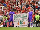 Liverpool players hold up a banner for Sean Cox in August 2018