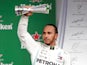 Lewis Hamilton celebrates on the podium with the third place trophy on November 17, 2019