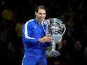 pain's Rafael Nadal celebrates with the ATP World No.1 trophy after winning his group stage match against Greece's Stefanos Tsitsipas on November 15, 2019