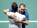 Britain's Dan Evans celebrates with captain Leon Smith after winning his match against Germany's Jan-Lennard Struff on November 22, 2019