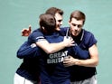 Britain's Jamie Murray and Neal Skupski celebrate with captain Leon Smith after winning their doubles match against Kazakhstan's Alexander Bublik and Mikhail Kukushkin on November 21, 2019