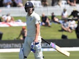 England's Rory Burns walks off the pitch dejected after his wicket is taken by New Zealand's Colin de Grandhomme on November 21, 2019