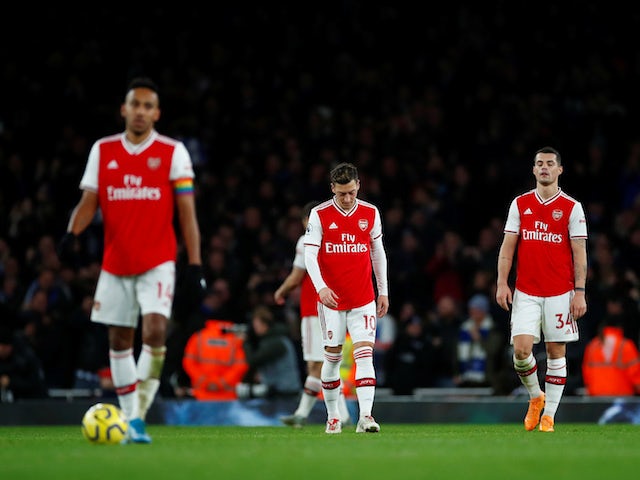 Arsenal's Mesut Ozil and Granit Xhaka look dejected after Brighton & Hove Albion's Neal Maupay scored their second goal on December 5, 2019